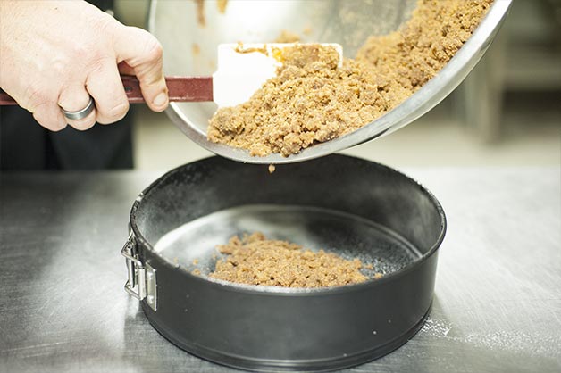 Chocolate Hazelnut Cheesecake Step 2 - Apply Biscuit Base to Oiled Tin 