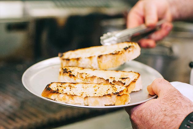 Cook your Artisan Garlic Batard in the oven, before toasting over the grill. 