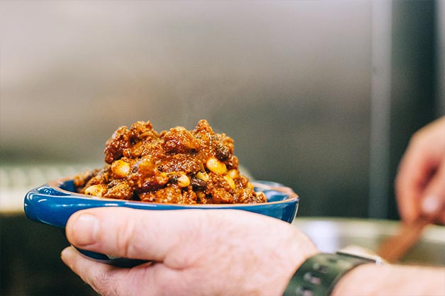 Add Three Bean Chilli to a bowl and season with salt and pepper