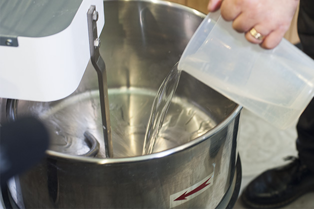 Add water, yeast, olive oil to mixer