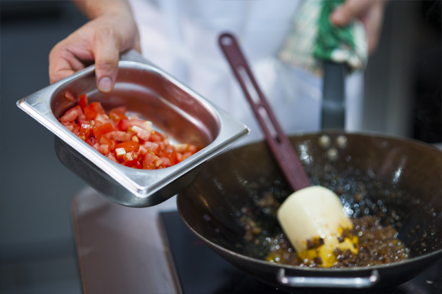 Putting tomatoes into the pot