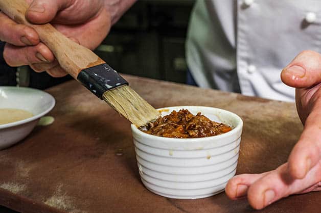 Placing the cooked mixture into the pot