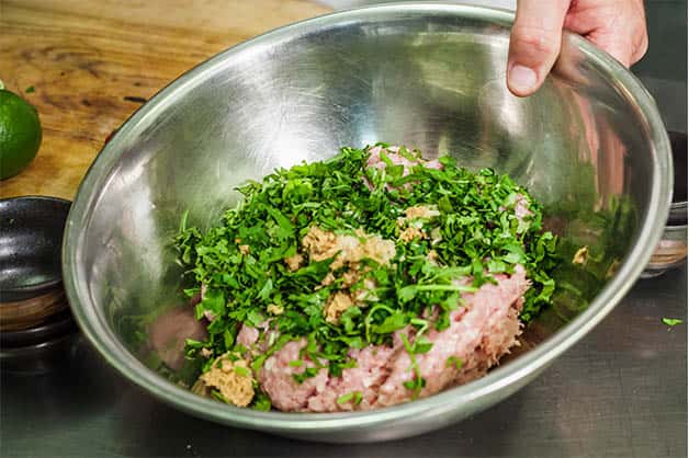 Adding spices to the raw chicken mince