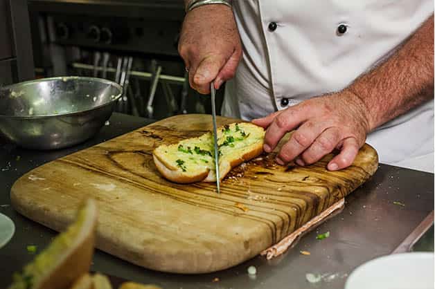 Evenly slicing the toasted bread