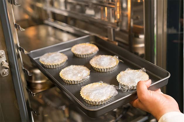 Filling the shells with rice and baking them