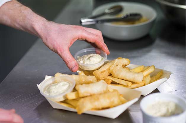Chef serving the fish and chips