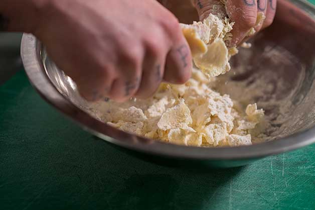 Chef mixing the ingredients to make the cheddar stable