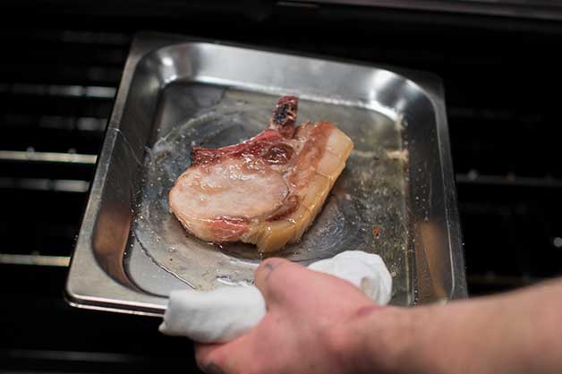 An image of the pork cutlet being soaked in the glaze