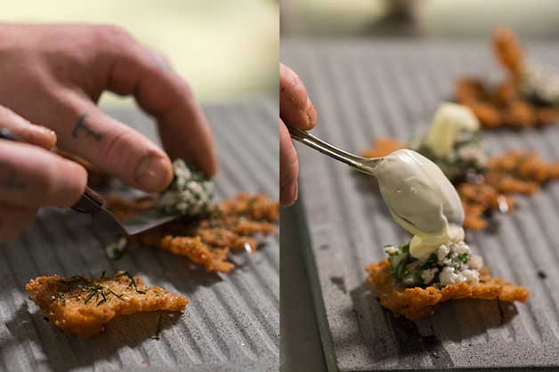 Chef adding the tartare on the cracker