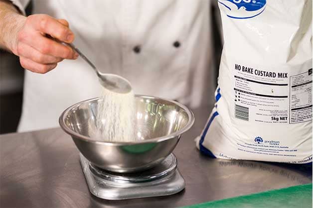 Chef is measuring the White Wings Custard Mix