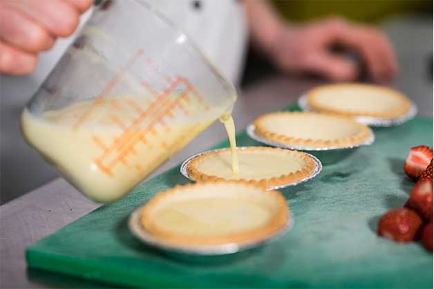 Chef pouring the custard mixture into the Pampas Baked Shells