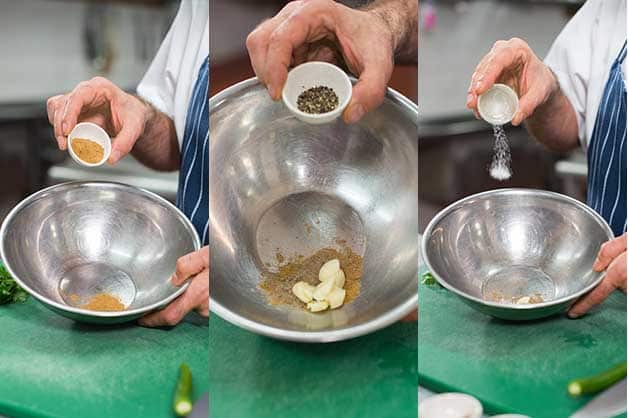 The chef is seen combining the spices for dressing