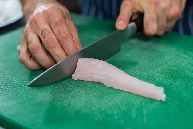 The chef now slices the flathead fillets