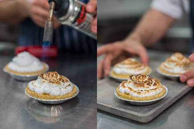 The chef then blow torches the top of the filled tartlets