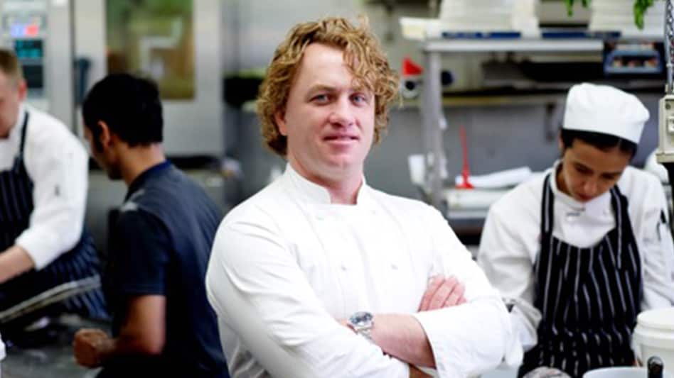 A photo that shows Adrian Richardson standing in the kitchen