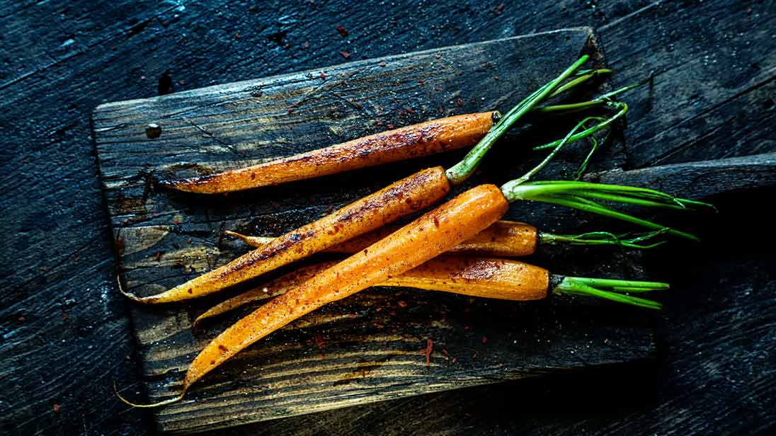 Image of a whole carrot being used to cook with