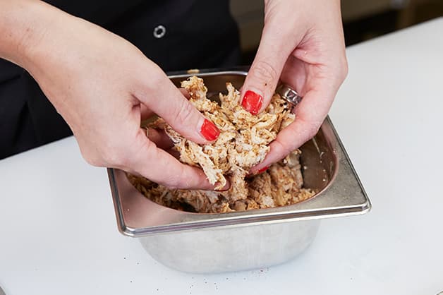 Chef is seen adding the paprika to the chicken