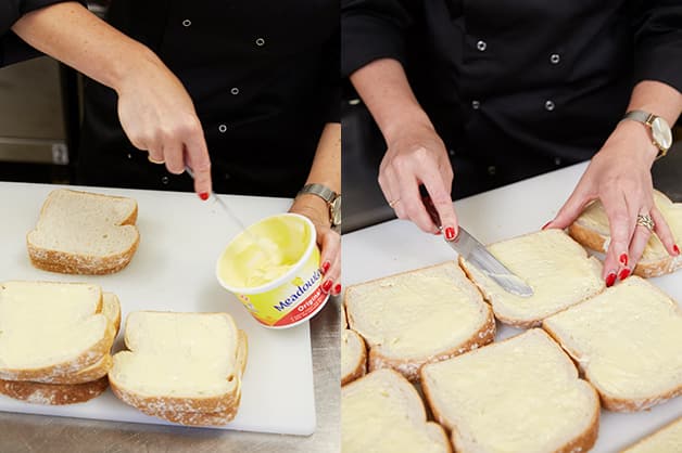 The chef is seen buttering the two loaves of bread