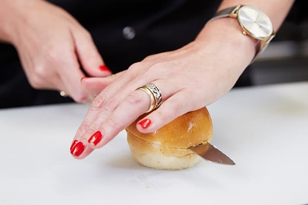 The chef is pictured slicing the milk bun sliders in half