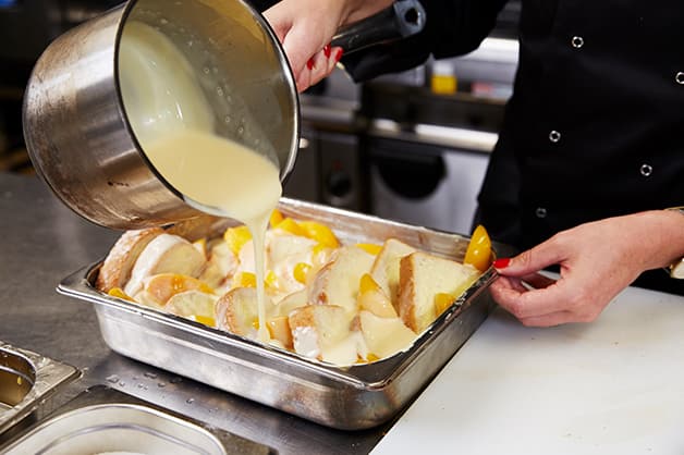 She is then pictured pouring the custard over the bread