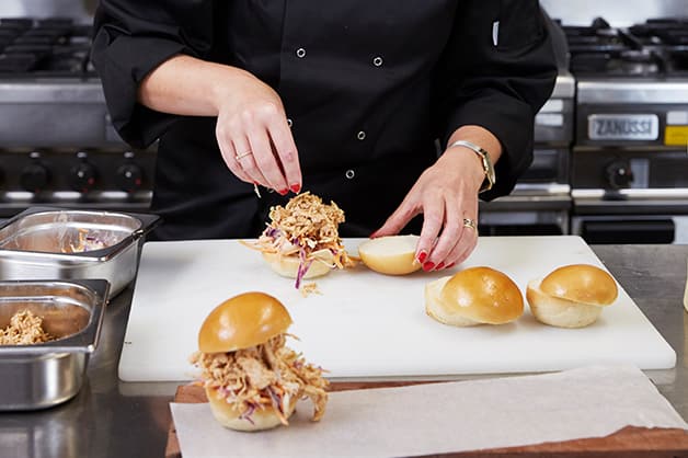 The chef is seen assembling the sliders