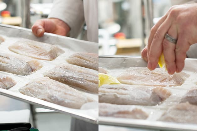 Chef is seen dressing the raw barramundi with lemon and salt