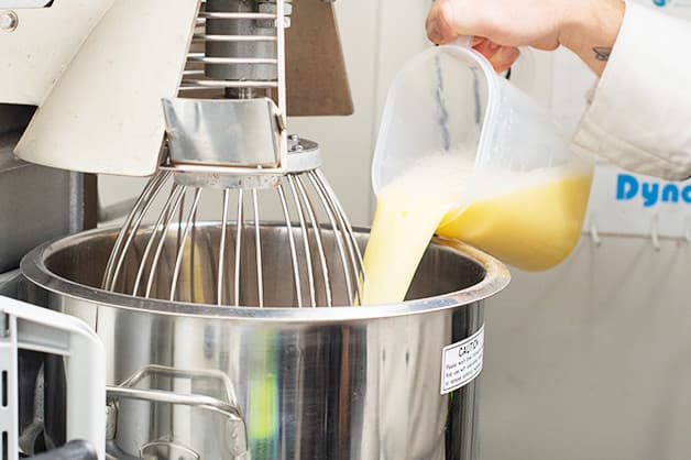 The chef is pictured combining the cake mix and eggs