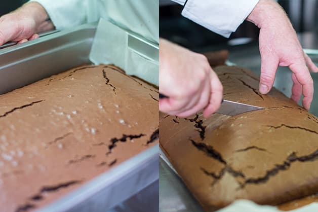 The chef is pictured slicing the chocolate cake