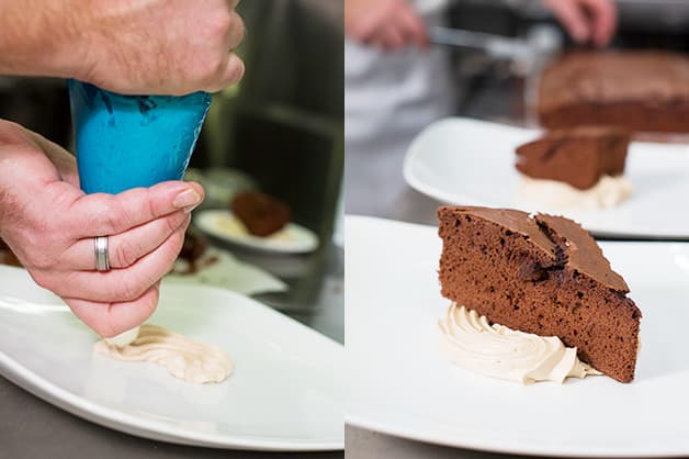 Here the chef is pipping the cream and placing cake on top