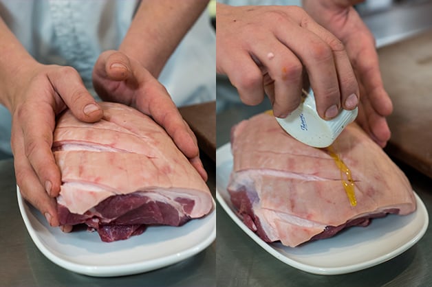 The image shows the chef preparing the pork shoulder