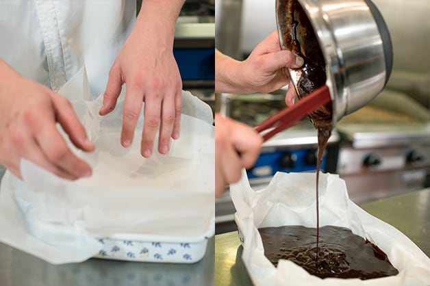 The chef is seen pouring the brownie mixture into the tray