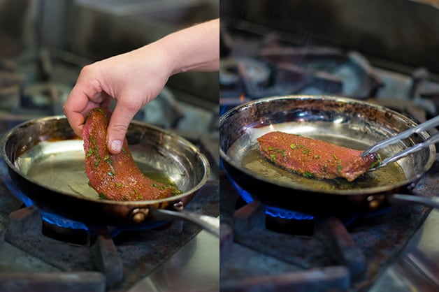 The chef is seen frying the lamb steak