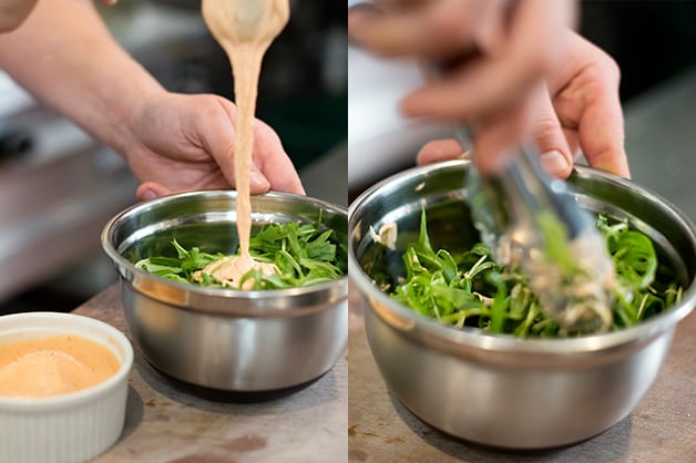 The chef is pictured combining the sauce and the rocket