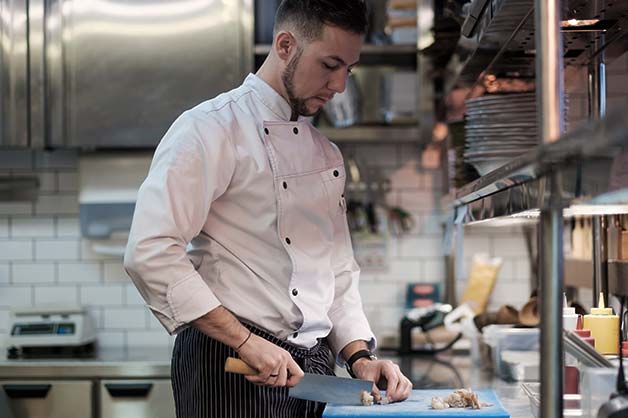 Chef cutting vegetables in the kitchen