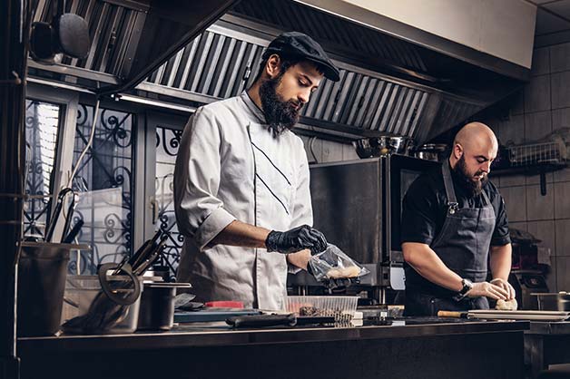 Chef working on the bench in a kitchen