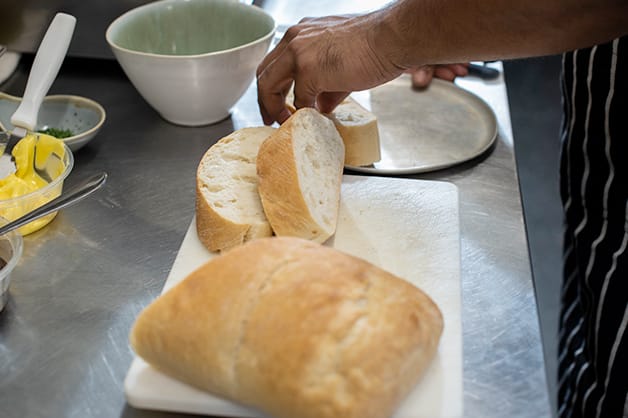 Chef is pictured slicing the QBA Ciabatta Loaf