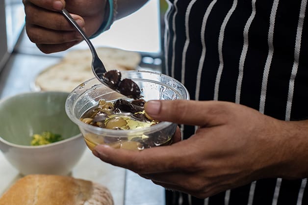 This image shows black and white garlic covered with olive oil