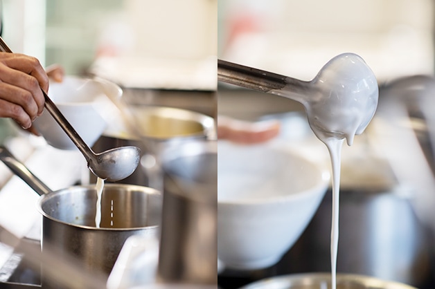 Chef adding milk and coconut cream to the pot