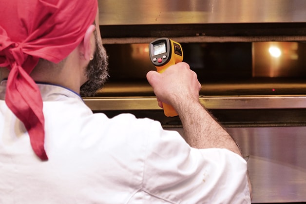 Chef checking the status of his meat using a thermometer