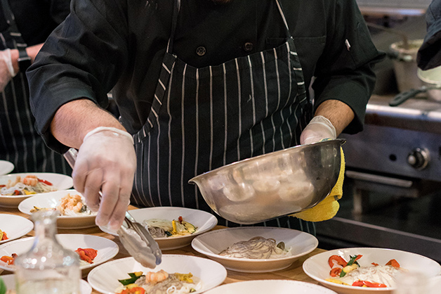 Image of a chef dishing up a plate