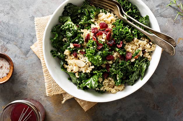 The photo is of quinoa being added to a salad