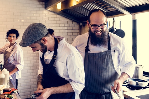 Image shows three chefs working in the kitchen