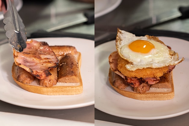 Stacking a sandwich with sausage, bacon, hashbrown and egg 