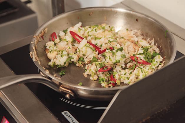 Chef is pictured frying all of the Rice with the spices