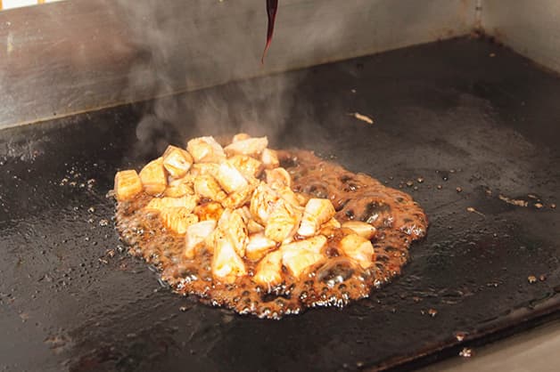 Image is of the chicken being caramelised on the grill