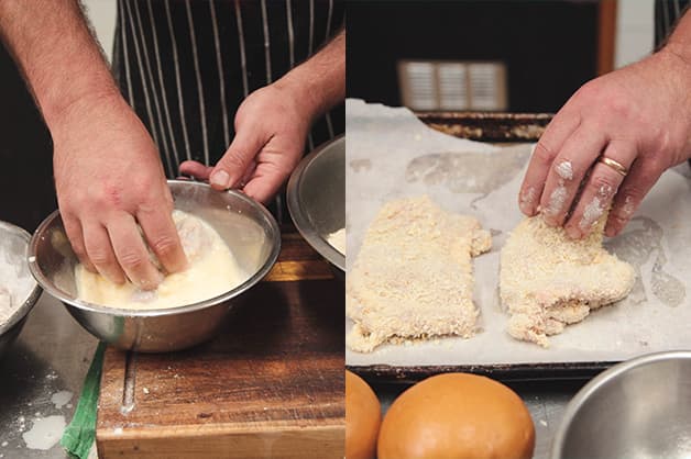 Image is of the chef coating the chicken with breadcrumbs