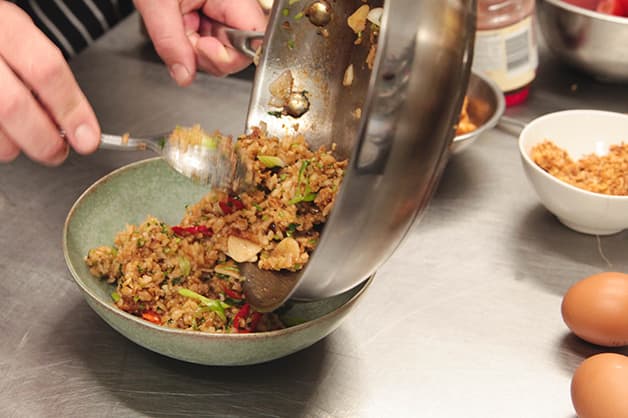 Chef is seen Pouring the mixture into the plate