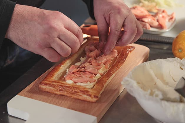 Image of the smoke trout being added to the pastry