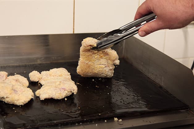Image is of the crumbed chicken being fried