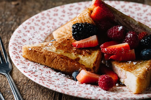 Image is of French toast with fresh berries